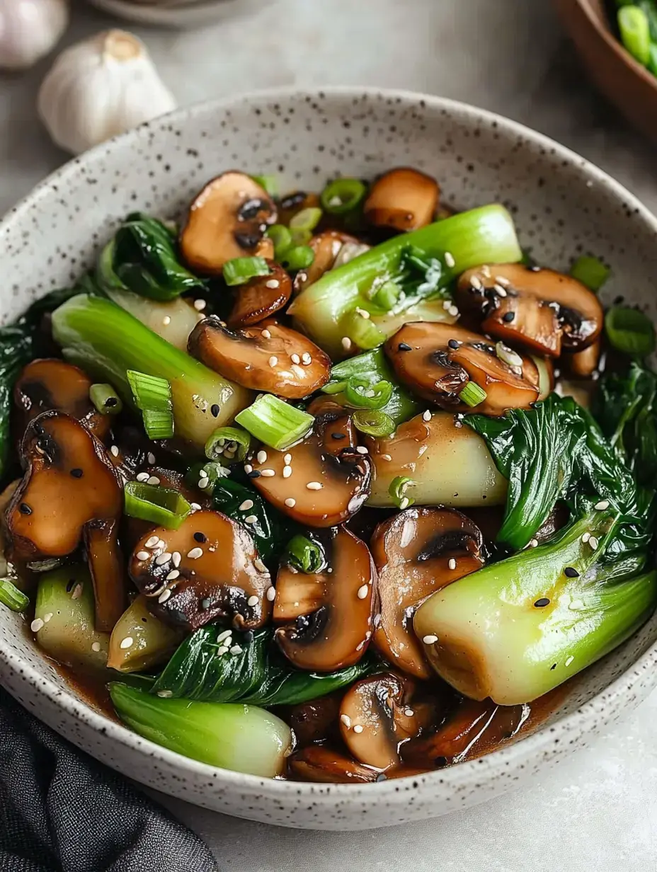 Un bol de pak choï et champignons sautés garni d'oignons verts et de graines de sésame.
